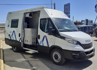 Furgoneta nueva, 
IVECO Camper,
Modelo  35S16A8V de 12m3,
Con cambio automático Hi Matic de 8 velocidades.  IVECO Daily Camper, una de las opciones más amplias del segmento con un espacio habitable de 12 metros cúbicos, con una longitud de 6 metros y una altura interior de 1,9 m. No obstante, estas dos últimas cifras pueden crecer hasta los 2,1 m de altura y 18 m3 de capacidad. Su carrocería presenta una amplia puerta corredera en el lateral derecho, escalón posterior y unas puertas traseras con apertura de 270º, sin olvidarnos de un habitáculo plano sin obstáculos. Su configuración polivalente permite que hasta 4 pasajeros viajen y pernocten en ella, con dos camas de matrimonio desmontables.  Toma como base la Daily destinada para uso profesional con mecánica diésel 2,3 litros Heavy Duty de 156 CV y 380 Nm de par motor, y cambio automático de 8 velocidades Hi Matic, destacando por ser una de las furgonetas con mayor maniobrabilidad del segmento.  Asimismo, cuenta con diversas ayudas sumamente interesantes para quienes no están acostumbrados a conducir este tipo de vehículos, como es por ejemplo el asistente de viento lateral.  Respecto a su interior, dice la marca que ha empleado materiales ligeros y duraderos basados principalmente en varios tipos de plásticos. Así pues, nos encontramos con un espacio capaz de albergar a cuatro huéspedes perfectamente equipado. La parte trasera se ha pensado de forma modular, pues cumple las funciones de dormitorio con una litera compuesta por dos camas de matrimonio de 198 x 130 cm con un baúl de almacenaje, comedor para esas cuatro personas, así como maletero con capacidad suficiente para guardar en él unas bicicletas o una pequeña motocicleta.  Dispone también de un baño completo con inodoro, lavabo y ducha, además de una cocina con dos fuegos, fregadero de un seno y nevera-congelador de 75 litros, estando todas las “estancias” perfectamente iluminadas gracias a las tres claraboyas y una iluminación interior 100 % LED. En cuanto al abastecimiento, corre a cargo de un depósito de 90 litros de aguas sucias y limpias y de una una placa solar de 160 W, siendo además capaz de suministrar corriente a 220 V con una potencia máxima de 1.500 W.  No obstante, para quienes prefieran tomar el aire fresco incluye un toldo de 3,7 metros y un foco LED bajo el cual poder colocar la mesa y sillas de camping. En el apartado multimedia cuenta con lo más esencial, como es una radio DAB, conexión USB y manos libres Bluetooth, aunque carece de la ya necesaria conectividad Android Auto y Apple CarPlay.